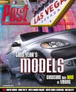 Silver car with text '2005 YEAR'S MODELS' and 'CRUISING the NAB in VEGAS' in front of a Las Vegas, Nevada sign.