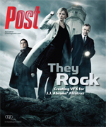 Three people stand on rocks with a tower behind them. The central figure is a woman in a trench coat. The text "Post" is visi