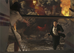 A woman reaches from an airplane toward a man running through thick smoke and large flames.