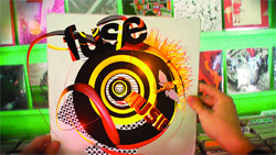 Hands hold a white vinyl record cover featuring bold, colorful abstract graphics and the words 'fuse music'.