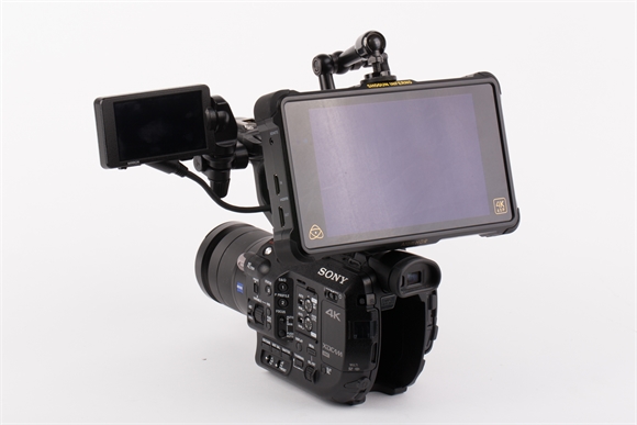 A black Sony 4K professional video camera with a large attached monitor and a smaller side monitor.