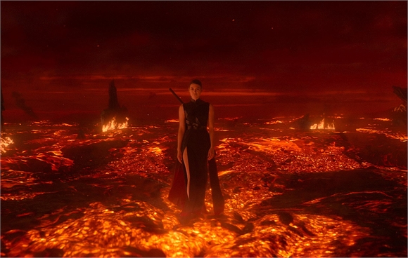 A person stands in the center of a vast, glowing landscape of molten lava under a dark red sky.