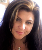A woman with dark hair and blonde highlights looking toward the camera.