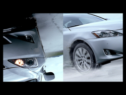 Close-up view of a silver car's headlight and front fender.
