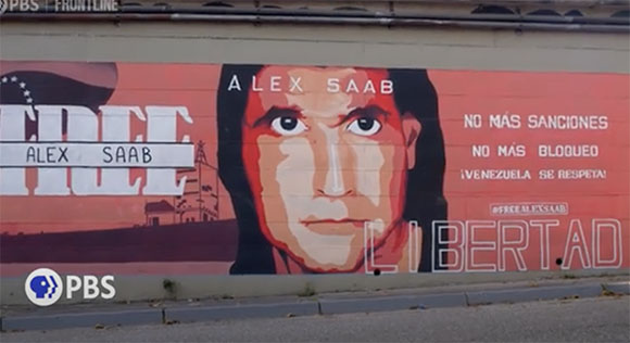 A large mural on a wall featuring a portrait of Alex Saab and text in Spanish and English.