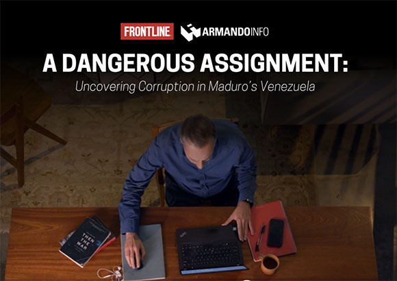 A man works at a desk with a laptop and books under large white text about uncovering corruption in Venezuela.