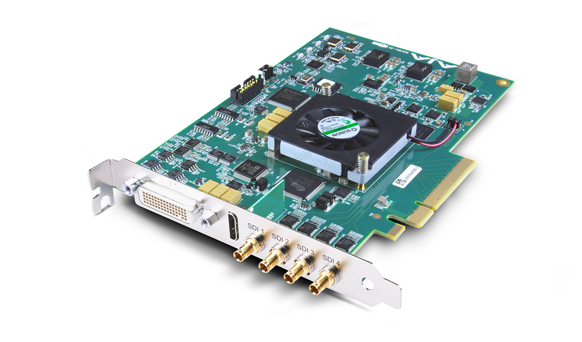A green electronic expansion card with a small black cooling fan and four gold BNC connectors.
