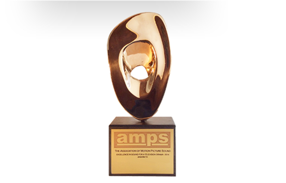 A gold, abstract-shaped trophy mounted on a black rectangular base with gold lettering.