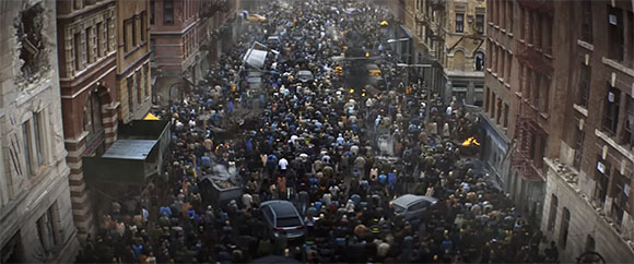 A dense crowd of people fills a narrow city street between tall buildings amidst smoke and vehicles.
