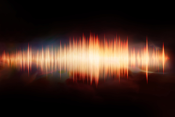 A glowing orange and yellow waveform with vertical spikes against a dark, smoky background.