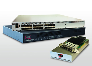 Two stacked network switches and one smaller network interface card on a plain background.