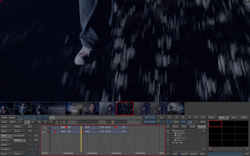 A video editing timeline displaying a shot of a person's leg and foot walking through heavy rain.