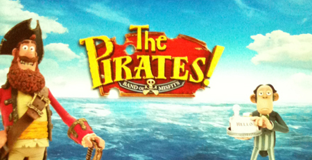 Animated pirate character and a monkey holding a cake against a blue ocean background with movie title text.