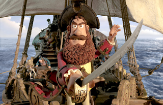 A claymation pirate with a large brown beard and tricorn hat holds a sword on a sailing ship.