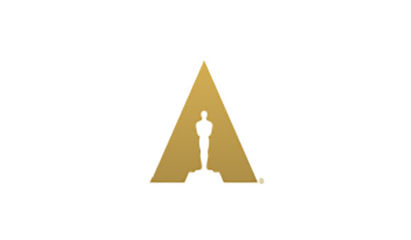 A gold triangle containing a silhouette of an Oscar statuette on a white background.