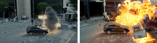 A dark car drives past a large explosion of smoke and fire on a city street.