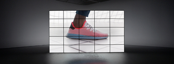 A large grid of screens displaying a close-up of a red and white athletic shoe.