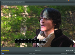 A man with dark hair and a white streak in a dark cloak looks off-camera against a forest background.