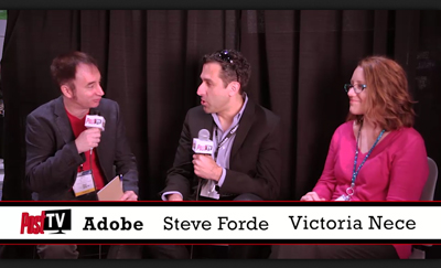Three people sit at a table with microphones during a panel discussion against a black curtain.