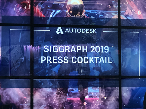 Autodesk logo and text SIGGRAPH 2019 PRESS COCKTAIL displayed on a screen with a background of a person in a helmet and a cos