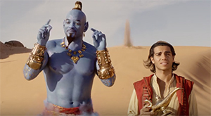 A blue genie with gold jewelry stands next to a young man in a red vest in a desert.