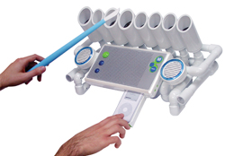 Hands using a blue wand and a remote to operate a white device made of PVC pipes and electronic components.