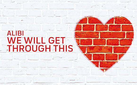 Red text reading 'ALIBI WE WILL GET THROUGH THIS' next to a red heart shape on a white brick wall.