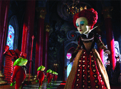 A woman with pale skin and red hair wears a black and gold gown in a dark, ornate hall with red columns.