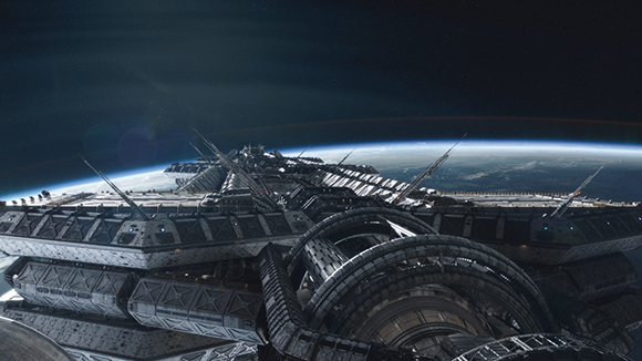 A large, dark, metallic spacecraft with intricate mechanical details orbiting a blue planet in space.