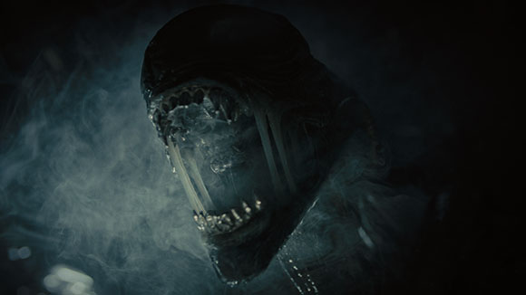 A dark, monstrous creature with an open mouth revealing rows of sharp teeth amidst swirling smoke.