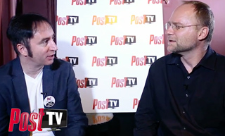 Two men sit facing each other during an interview in front of a white backdrop with Post TV logos.
