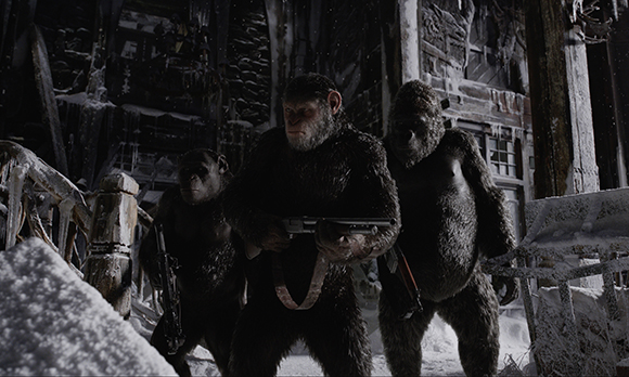Three chimpanzees stand amidst snow and debris in a dark, ruined setting.