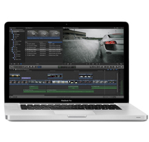 A silver laptop open on a white background, showing a video editing interface with a car scene.