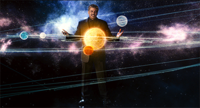 A man in a suit stands in space surrounded by glowing planets and orbital lines.