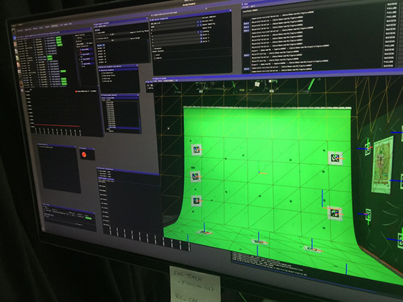 A computer monitor showing a dark software interface with data lists and a bright green 3D grid workspace.