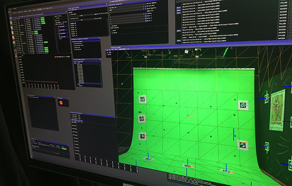 A computer screen showing a 3D modeling software interface with a green textured plane.