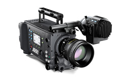 Professional black cinema camera with a large lens and an attached side monitor on a mounting arm.