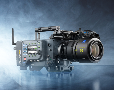 A professional cinema camera with a large lens and various attachments on a blue smoky background.