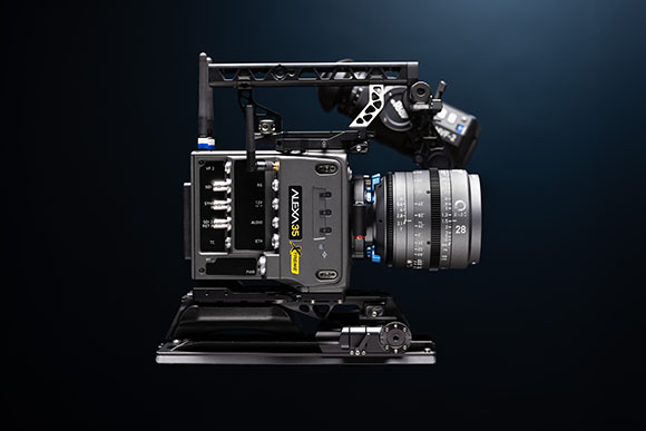 A black ARRI ALEXA 35 cinema camera with a large lens mounted on a baseplate against a dark blue background.