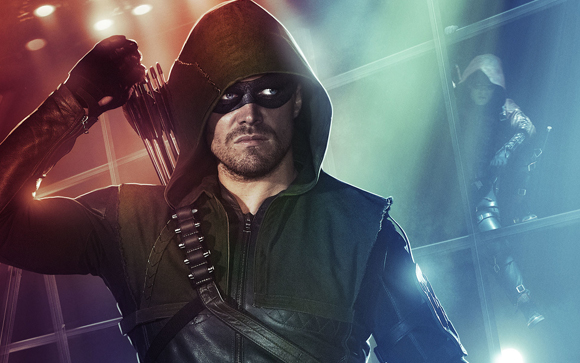 A man in a green hooded mask and tactical gear holds arrows against a blue and red lit background.