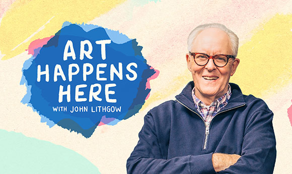 John Lithgow smiling with arms crossed against a colorful watercolor background.