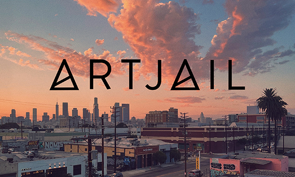 The word ARTJAIL in black capital letters over a city skyline at sunset.
