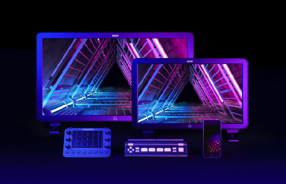 Three digital screens and two control consoles illuminated in vibrant neon blue and purple hues.