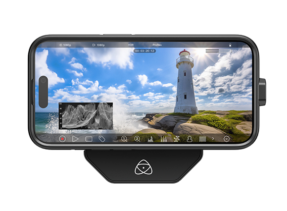 Smartphone in a black mount showing a video of a white lighthouse by the ocean under a blue sky.