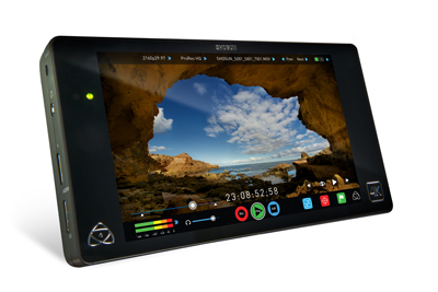 A black handheld video monitor displaying a landscape view of a coastline through a cave opening.