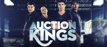 Four men posing together in a warehouse setting with the text 'Auction Kings' in the foreground.