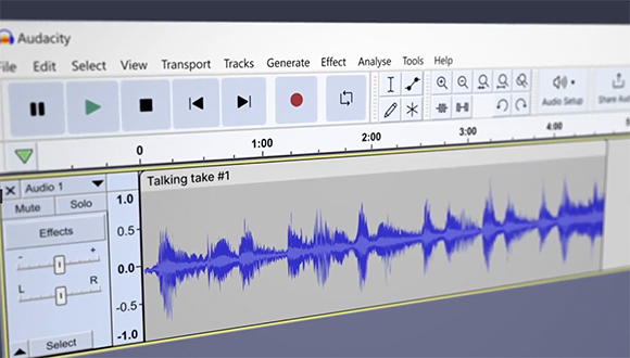 The Audacity software interface showing playback controls and a blue waveform for Talking take #1.