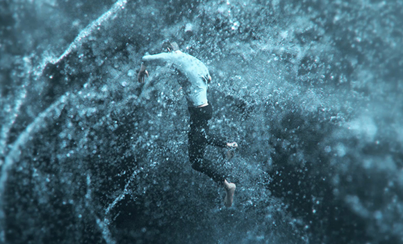 A person in mid-air falling through a heavy spray of water droplets against a dark blue background.