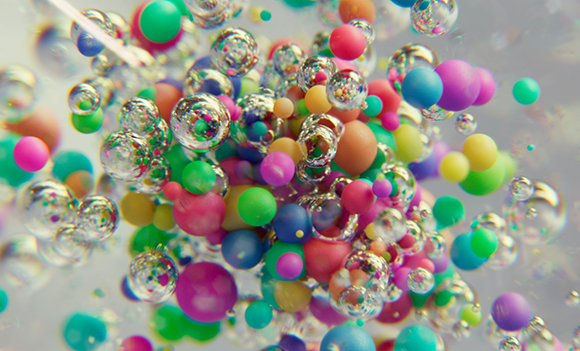 A vibrant, macro view of multicolored spheres and clear bubbles floating together in a dense cluster.