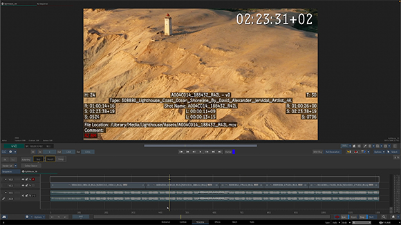 Video editing software interface displaying a wide shot of a lighthouse on a sandy landscape.